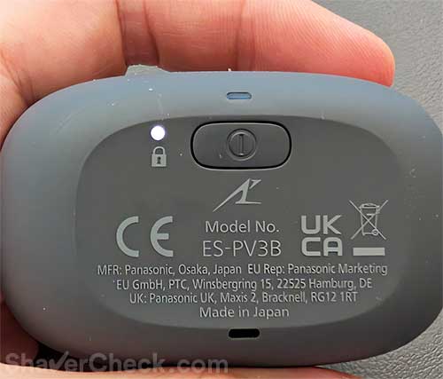 Activating the Panasonic Palm-sized 5-blade travel lock.