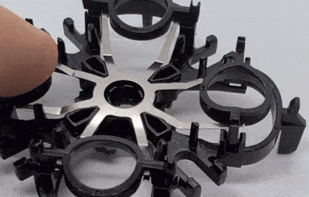 Flexing the springs that hold the four cutters.